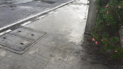 Puddles on the sidewalk on a rainy day
