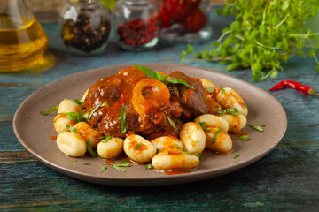 Ossobuco served with gnocchi.