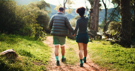 Couple, back and holding hands with nature for hiking journey, sightseeing or outdoor exploration....