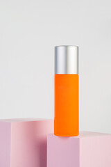 Skin care or sunscreen cosmetic with stylish props on white background.