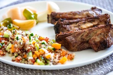 healthy superfood well balanced in nutrients, roasted pork chops, quinoa, salad, vegetables