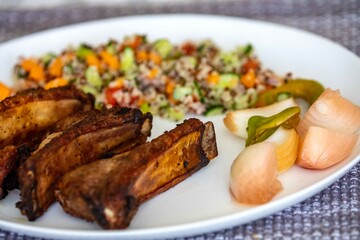 healthy superfood well balanced in nutrients, roasted pork chops, quinoa, salad, vegetables