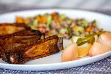 healthy superfood well balanced in nutrients, roasted pork chops, quinoa, salad, vegetables