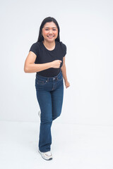 A cheerful young Asian woman captured in a full body shot running with energy, smiling confidently and showing determination. Isolated on a white background.