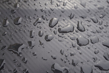 Water drops on the metal surface. Raindrops on the metal surface.