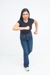 A motivated young Asian woman in a full body shot running forward, showing a strong and determined expression of focus. Isolated on a white background.
