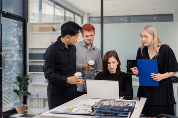 Financial analysts work overtime analyzing data on tablets, laptops, and graphs. Collaboration, teamwork, and planning.