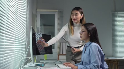 Businesswomen analyzing charts on computer in office - Powered by Adobe