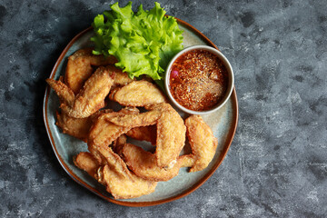 Crispy Fried Chicken wings with Fish Sauce serve with spicy dipping sauce