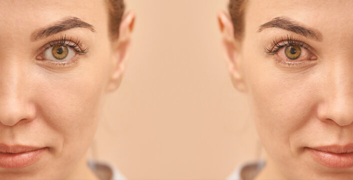 Close-up portrait of female face with brown eyes and subtle makeup on light background.