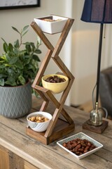 Rustic wooden tiered stand displaying snacks and plants