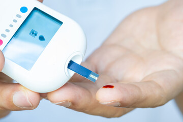 hand of people check diabetes and high blood glucose monitor with digital pressure gauge....