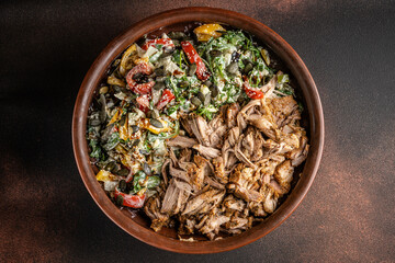 Pulled pork with salad in rustic bowl.