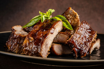 Barbecue pork ribs with glaze and basil.