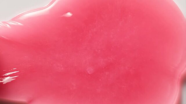 Closeup view showcasing a bright pink gel droplet resting elegantly on a surface