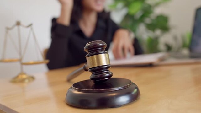 Judge gavel and justice scales on legal desk. Represents courtroom authority, legal order, and law enforcement.