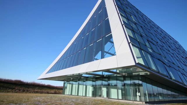 Architectural marvel: A pyramidal glass building reflecting innovative design principles