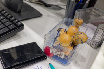 Copy stamp on desk with monitor and clear tray of stamps