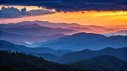 Fototapeta premium Vibrant sunset over layered blue mountains