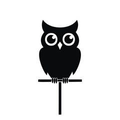 Black owl silhouette perched on a branch bird