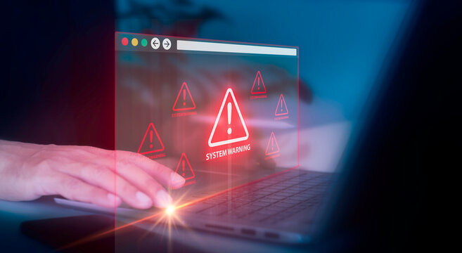 A person working on laptop with futuristic interface showing critical error signs, system failure, and cyber risk notifications. System warning alert with AI and data error concept.