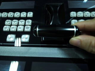 Top view of man's hand control video switcher in television and broadcast system.	