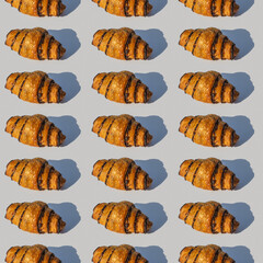 Chocolate croissant on gray background.