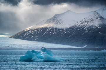 Iceberg on Jokulsarlon Iceberg Lagoon backed by the Breithamerkurjokull Glacier, Vatnajokull National Park, Southern Iceland, Europe