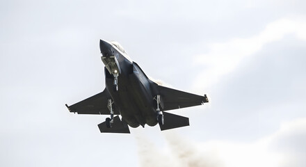 An advanced F-35 Lightning II fighter jet with landing gear deployed for approach or hovering.