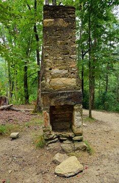 the ruins of  an historic homestead chimney  in the forest along the stone mountain loop trail  in stone mountain state park,  near roaring gap, in northern north carolina