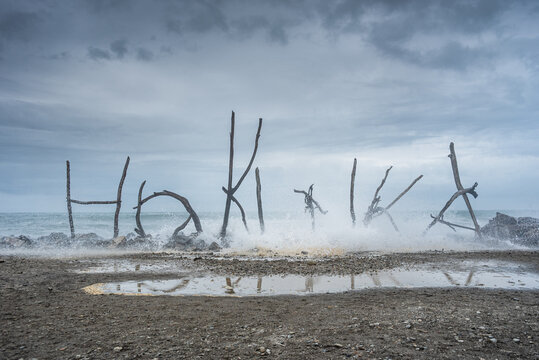 Creative Driftwood &acirc;&euro;Hokitika&acirc;&euro;&trade; Beach Sculpture Against Stormy Sky on the West Coast, New Zealand