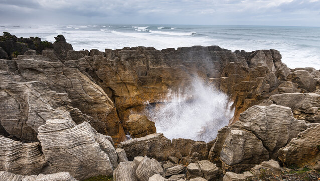 Seawater Blasting Through Blowhole in Sculpted Rock at Pancake Rocks, Punakaiki, New Zealand