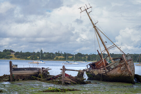 Wrecked boats by the waters edge at Pin Mill, near Ipswitch in the county of Suffolk, United Kingdom