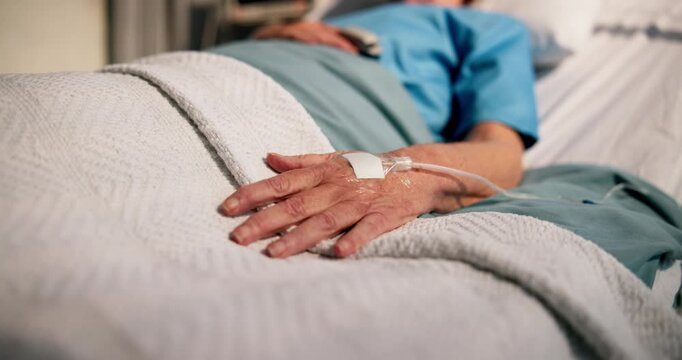 Hand, elderly patient and IV drip in hospital bed for medical treatment, hydration or surgery recovery. Healthcare, sick senior person and intravenous fluid in ICU clinic for morphine and pain relief
