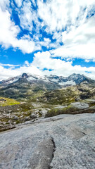 Austria, 08-2025 :wide shot of mountains and glaciers, near the weißsee lake. Cloudy blue sky.