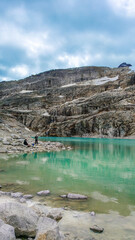 Austria, 08-2025 : wide shot of a glacial lake, near the weißsee lake. Moutains and cloudy sky in background.