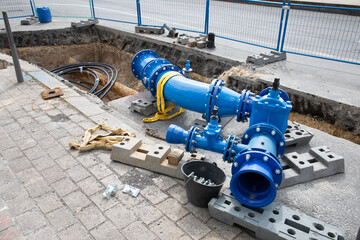 water repair site in the street changing drinking water pipes in blue steel and taps