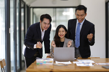 Business meeting, group of successful businessmen having fun and congratulating their colleagues in the office. Successful teamwork with coworkers.