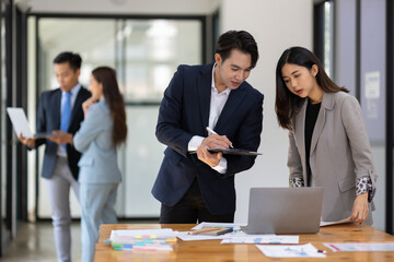 Business meeting, coworkers are discussing in the conference room.