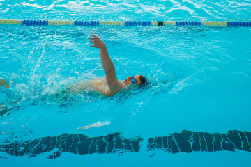 Swimmers training in the pool. Backstroke style. Sports, determination and endurance. Swimming...
