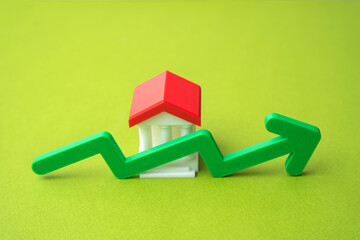 Bank building and green up arrow. Growth of savings in the bank account. Rising bank capitalization, deposit growth, increasing consumer savings. Business and finance