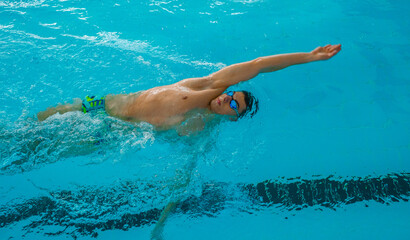 Swimmers training in the pool. Backstroke style. Sports, determination and endurance. Swimming...