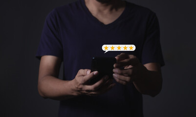 Review Customer, Young Man hand holding Smart Phone with five star to review and give 5 stars with very good results in service, Good review 5 star rating choice feedback