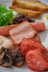 Delicious English breakfast with various components on a white plate.