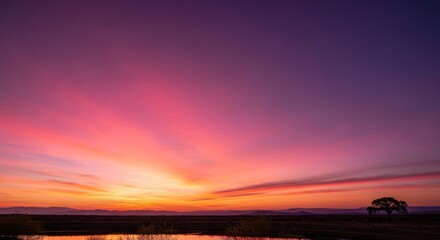 Fototapeta premium Vibrant sunrise over a tranquil landscape