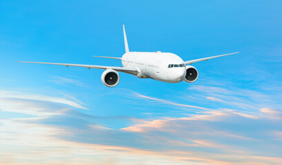 Obraz premium White passenger airplane flying in the sky amazing clouds in the background - Travel by air transport