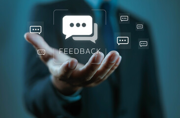 Businessman holding digital feedback icon with chat bubbles, symbolizing customer review, communication, survey, online response, business evaluation, client opinion, and service improvement concept.