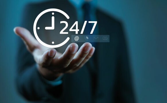 Businessman holding 24/7 service icon with clock, symbolizing customer support, availability, communication, digital business, reliability, hotline, online assistance, and nonstop professional service