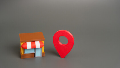 Shop building and location pin. Retail business location, local marketing, store finder services, geographic targeting, and importance of site selection in commerce. copy space