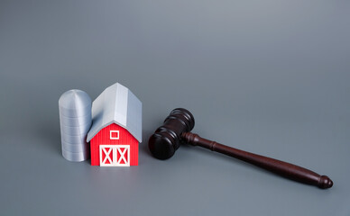 Judge's gavel and farm figurine. Legal issues in agriculture, land ownership disputes, farming regulations, rural law, and government control over agricultural practices.